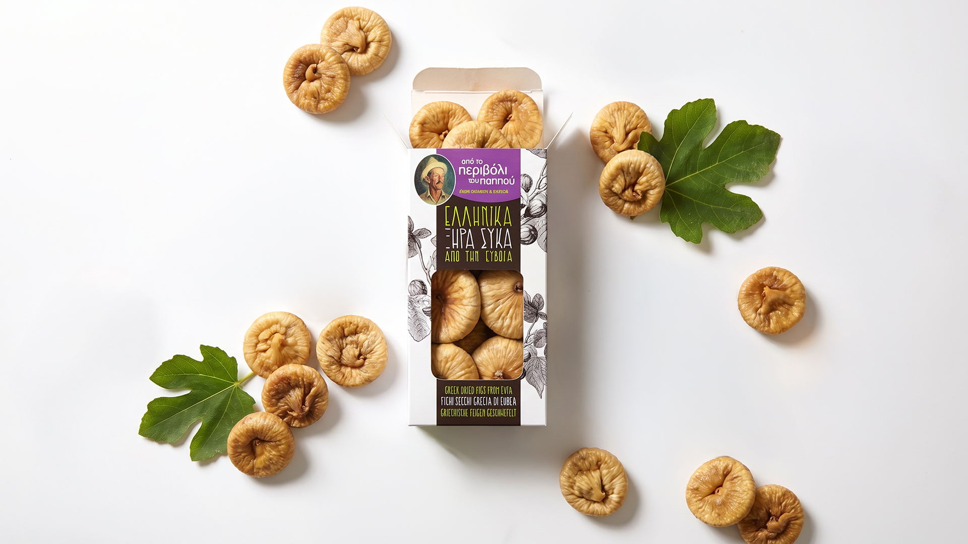Front view portfolio shot of a luxury Greek dried figs packaging sleeve by ABC Design, adorned with hand-drawn fig branch engravings and a classical portrait emblem on a clean studio background.