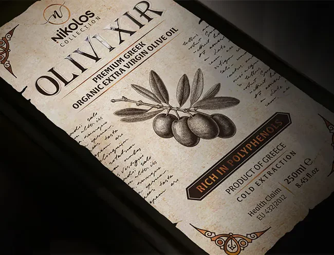 Premium textured label for Olivixir Nikolos Collection organic extra virgin olive oil, featuring a vintage design with torn edges.