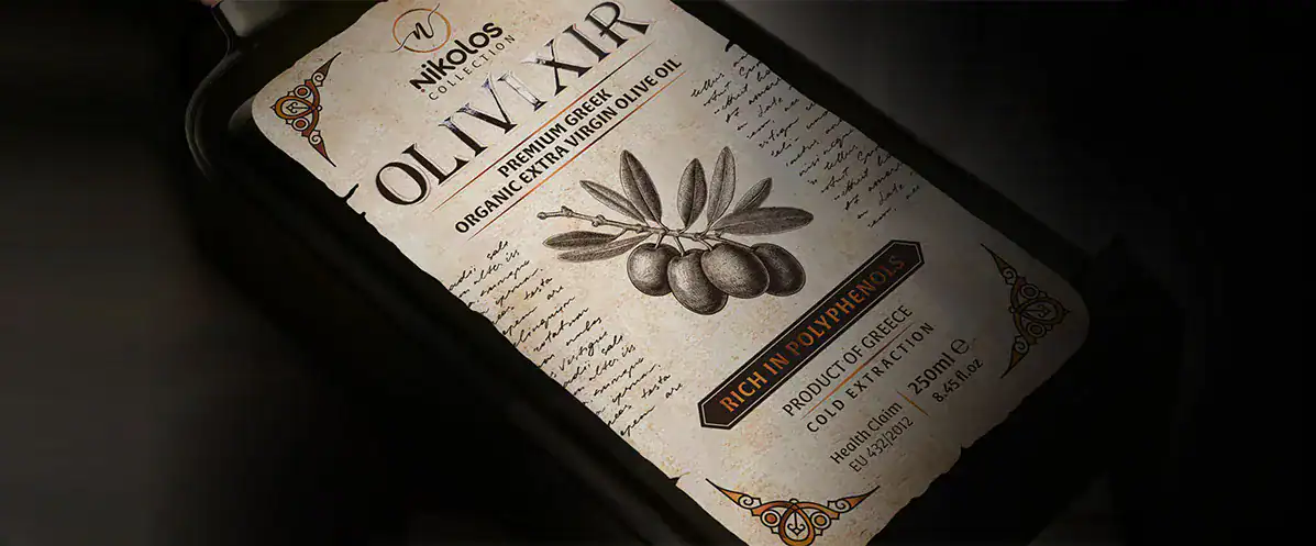 Premium textured label for Olivixir Nikolos Collection organic extra virgin olive oil, featuring a vintage design with torn edges.