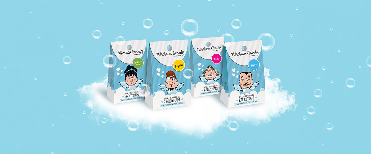 Premium packaging design for Nikolaou Family handmade olive oil soaps by ABC Design, illustrating custom character-driven brand storytelling on structured paper pouches floating amidst clouds and bubbles.