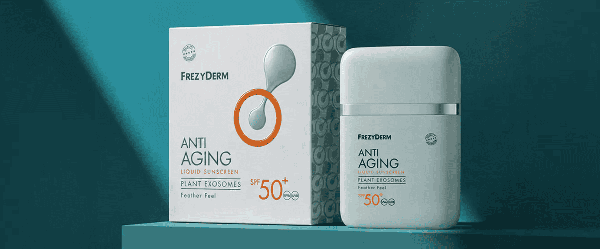 Minimalist packaging and bottle of Frezyderm Anti Aging Liquid Sunscreen SPF 50+ against a teal background.